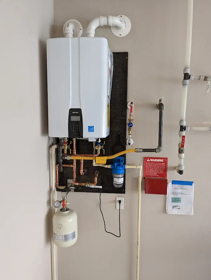 Professional plumber installing copper piping in a Taos home